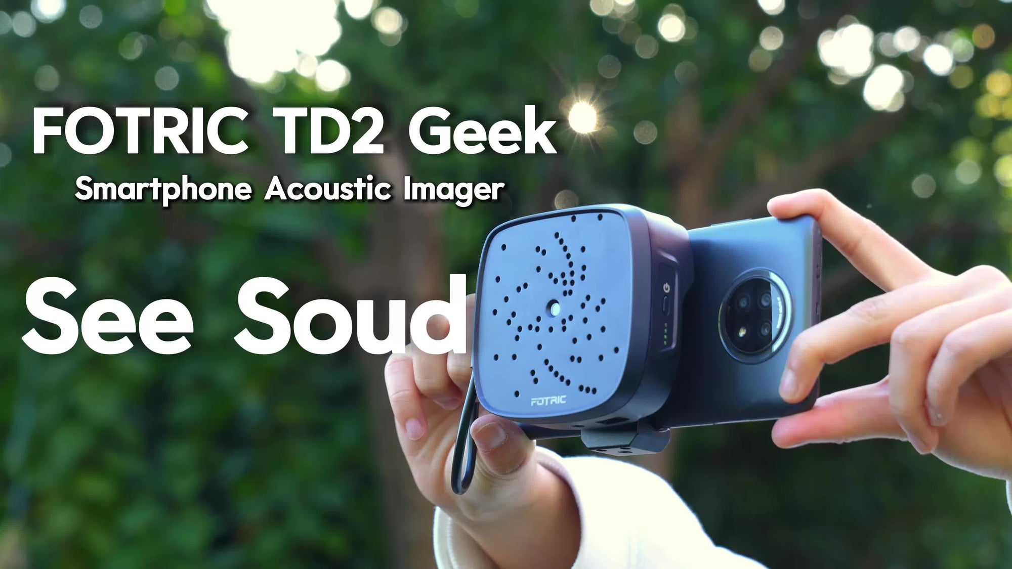 FOTRIC TD2 Geek smartphone acoustic imager held by a person with greenery in the background